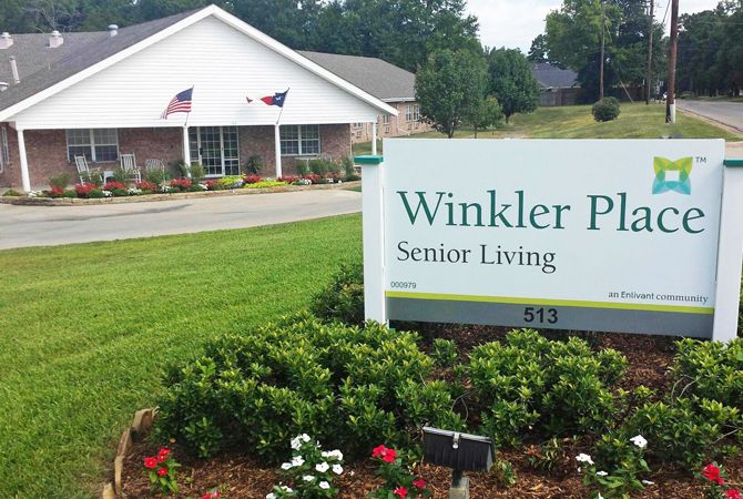 Winkler Place Senior Living facility with surrounding greenery and signage.