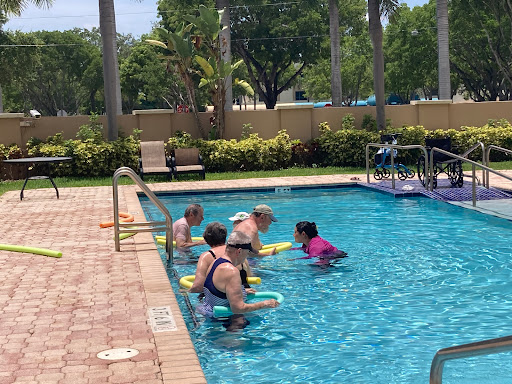 Friends enjoying a fun fitness session in the pool.