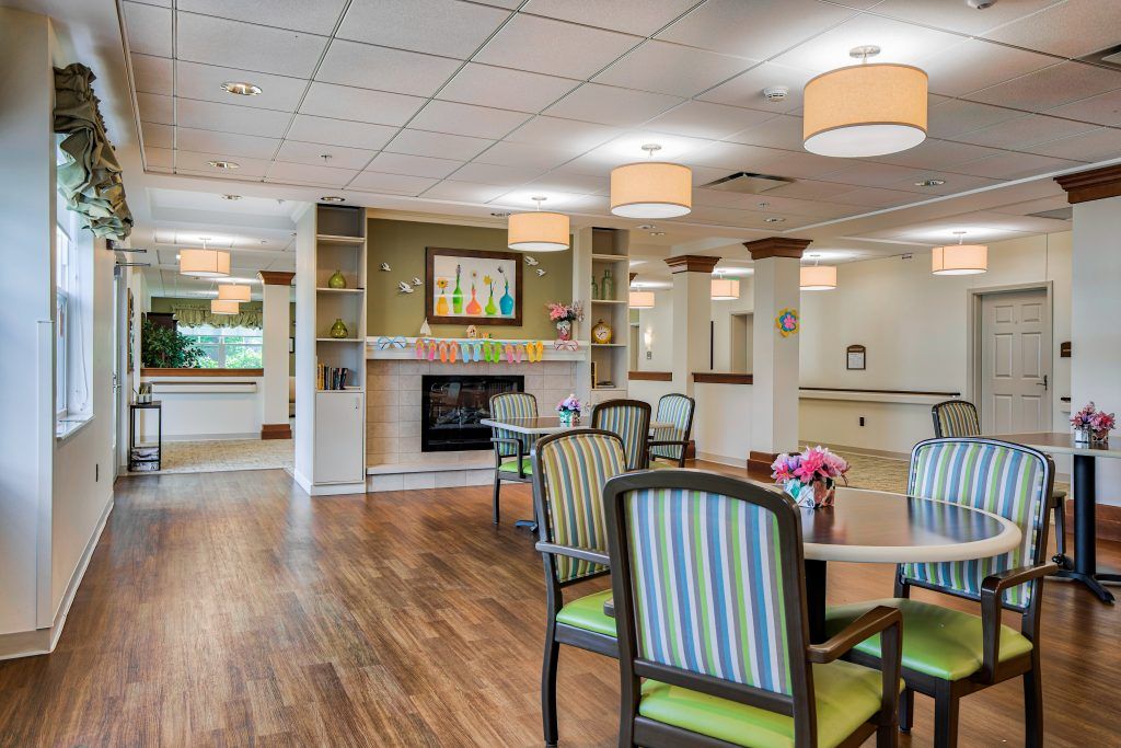 A modern dining area with striped chairs, wooden flooring, and ambient lighting.