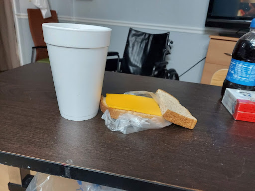 A simple snack of cheese on bread accompanied by a drink.