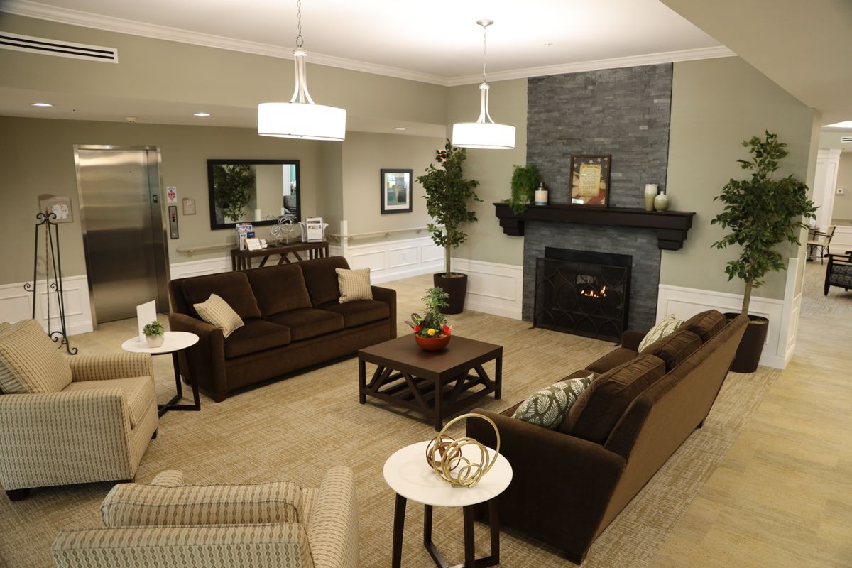 A cozy living room with comfortable seating and a modern fireplace.