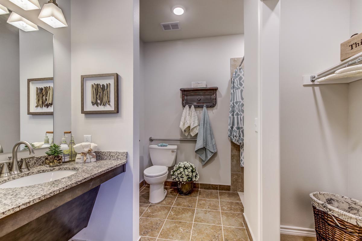 A modern bathroom with neatly arranged towels and decorative elements.