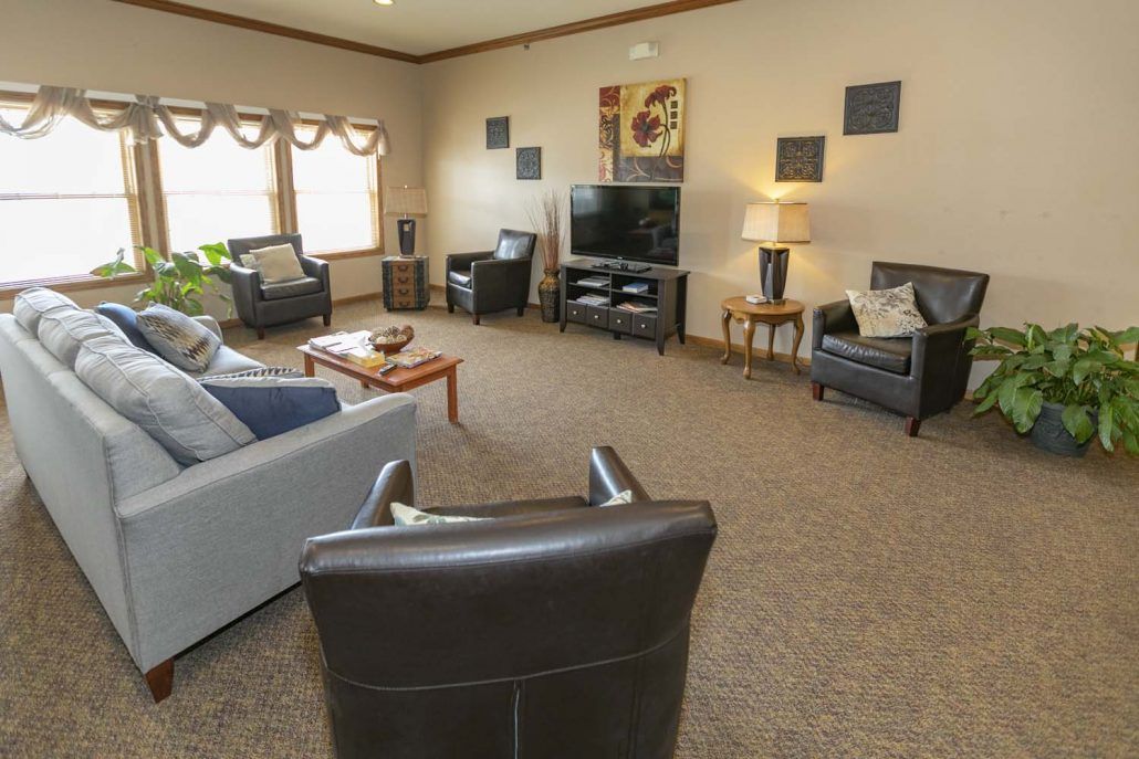 A cozy living room with comfortable seating and a large TV.
