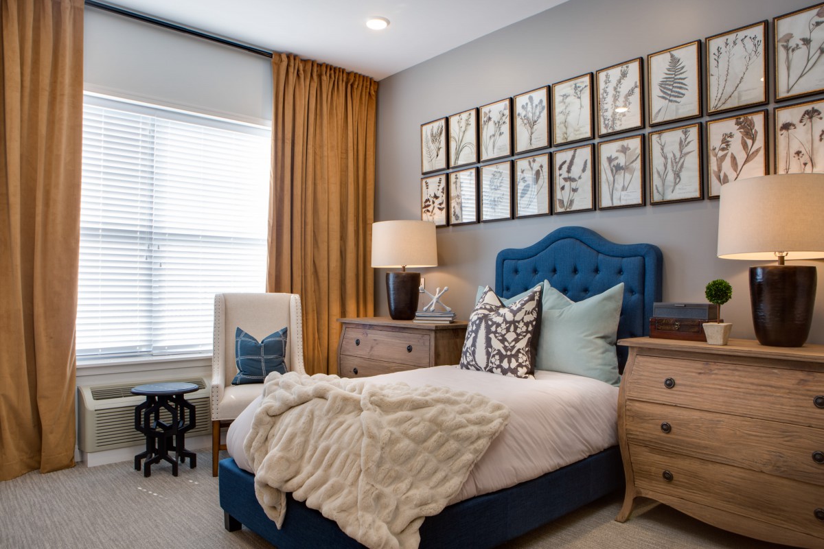 A stylishly decorated bedroom with plush furnishings and elegant wall art.