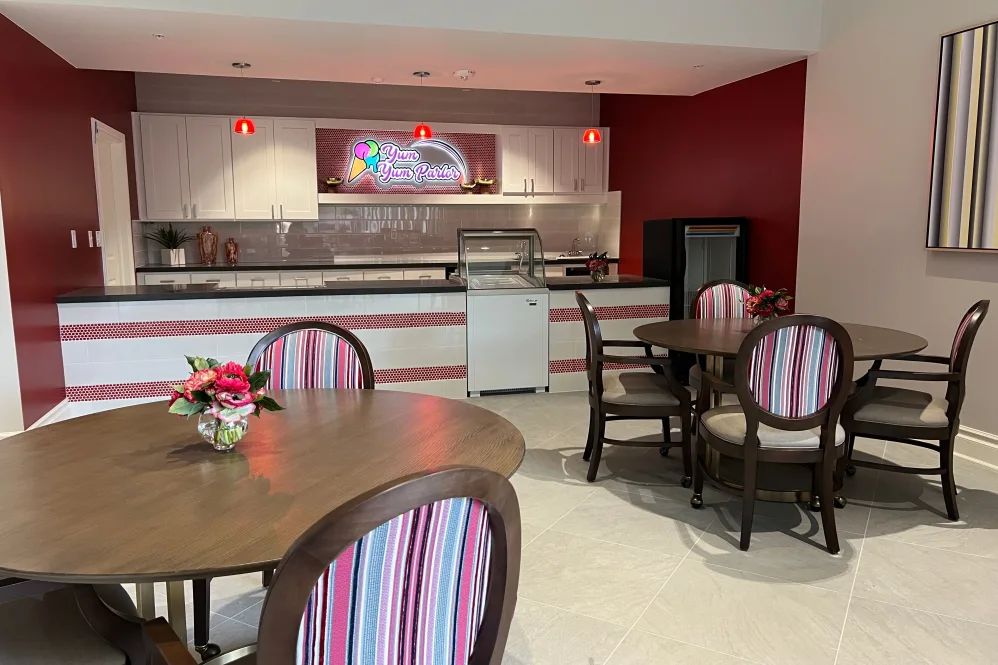 A cozy cafe with colorful striped chairs and tables ready for guests.