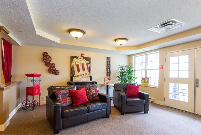 A cozy living room with a sofa, armchair, and decorative elements.