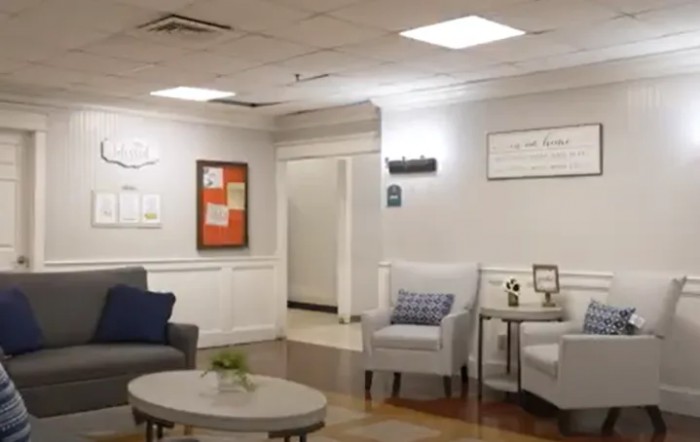 A cozy waiting room with comfortable seating and modern decor.