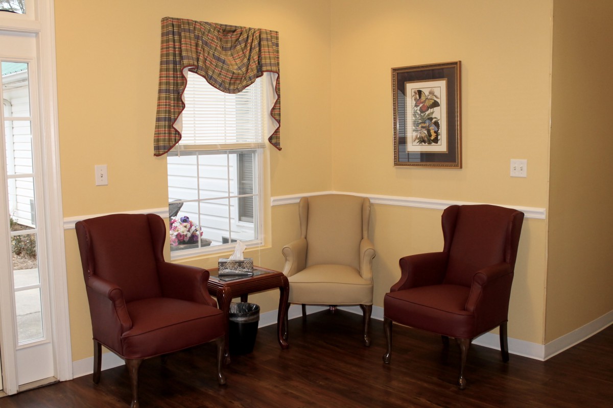 A cozy living room corner with traditional chairs and decor.