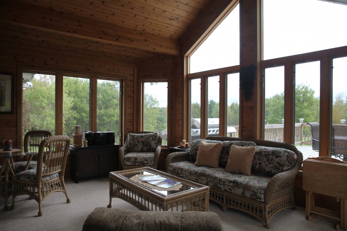 A cozy living room with large windows and comfortable seating.