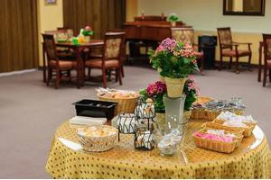A decorated table with flowers and snacks set up for an event.