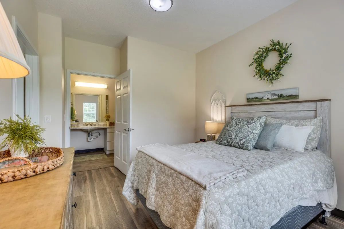 A cozy and minimalist bedroom with warm lighting and tasteful decor.