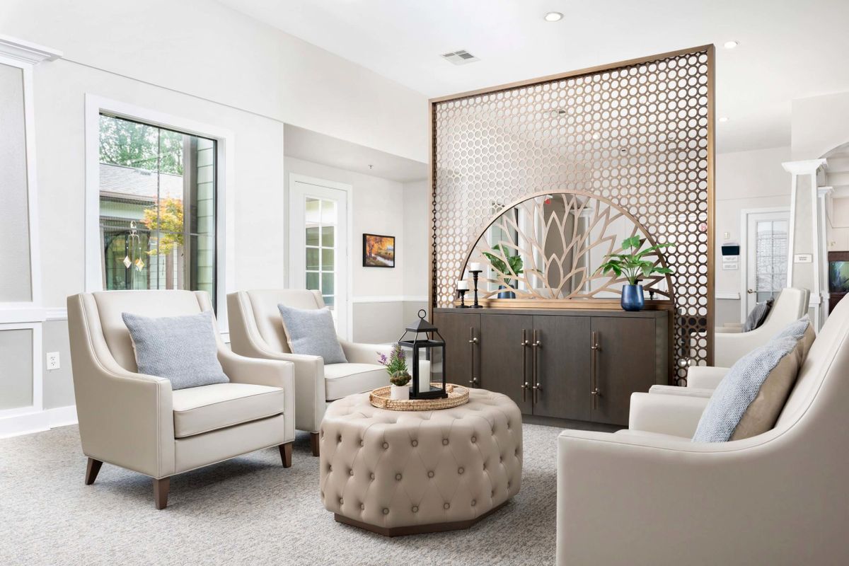 A modern living room with cozy chairs and a stylish partition wall.