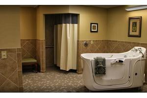 A bathroom featuring a bathtub and shower area with a curtain.