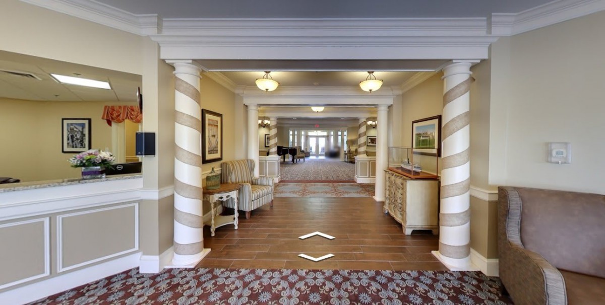 A well-lit hotel lobby with elegant decor and furniture.