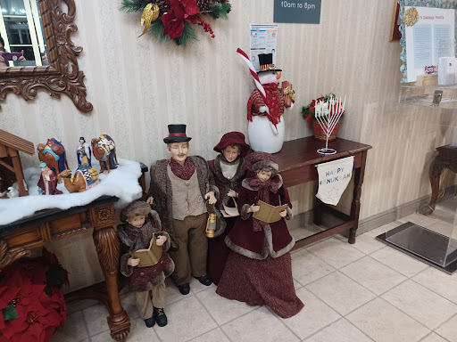A charming display of Christmas carolers and festive decorations in a cozy indoor setting.