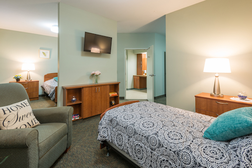 A cozy and well-furnished hotel room with modern amenities.