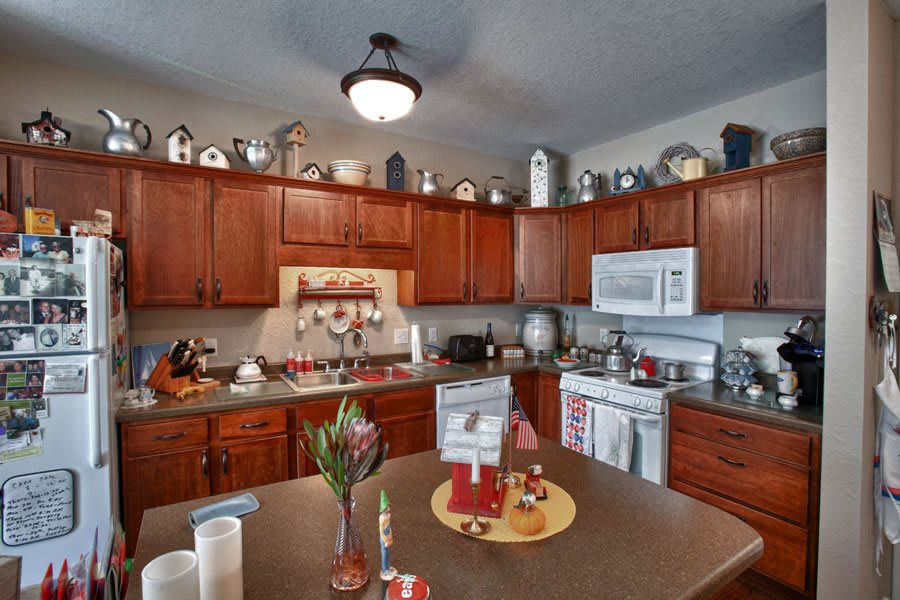 A cozy kitchen with wooden cabinets and modern appliances.
