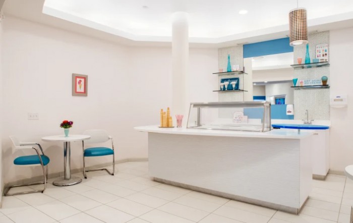 A modern reception area with minimalist design elements and bright lighting.