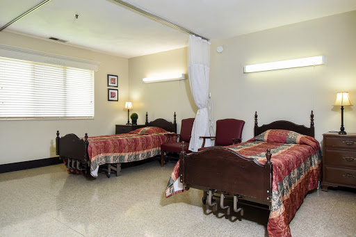 A cozy shared bedroom featuring twin beds and warm lighting.