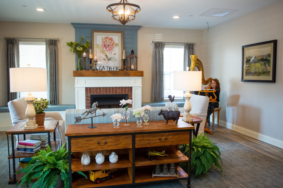 A beautifully decorated living room featuring a fireplace, elegant furniture, and stylish artwork.
