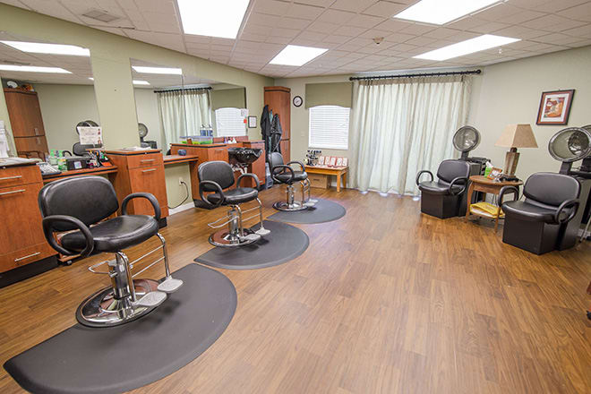 A cozy barbershop with styling chairs and mirrors, ready for customers.