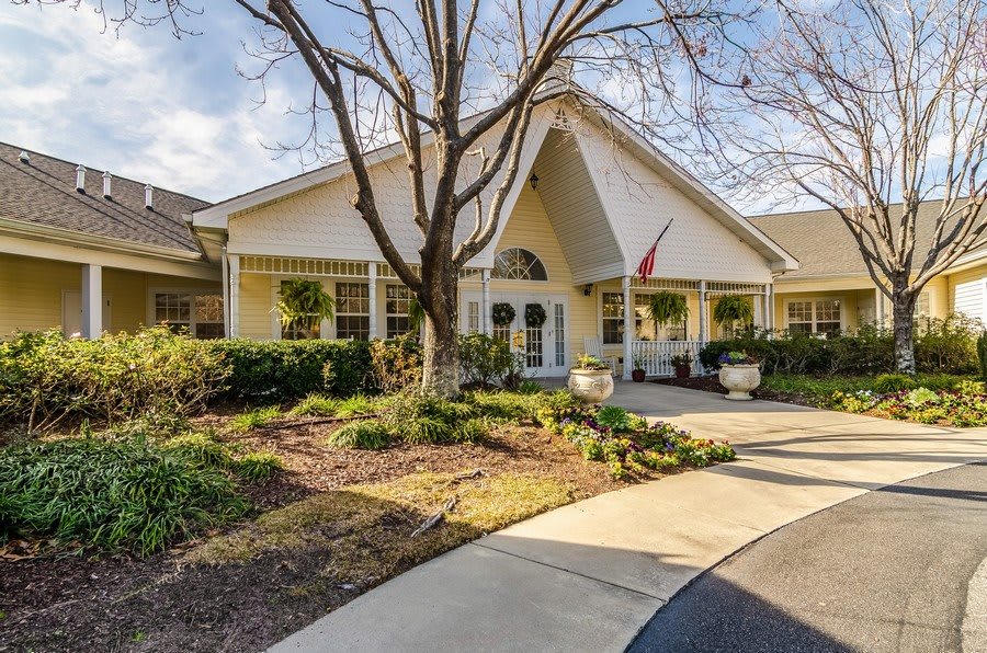 A welcoming residential building with a landscaped garden and winding walkway.