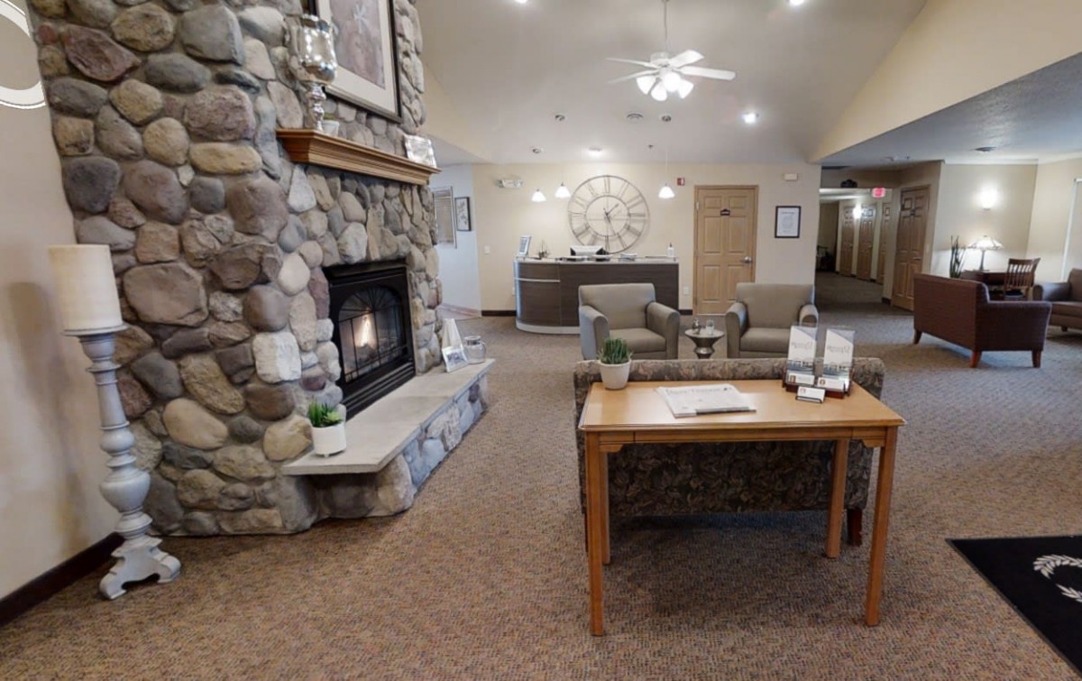 A cozy lobby with a stone fireplace and comfortable seating.