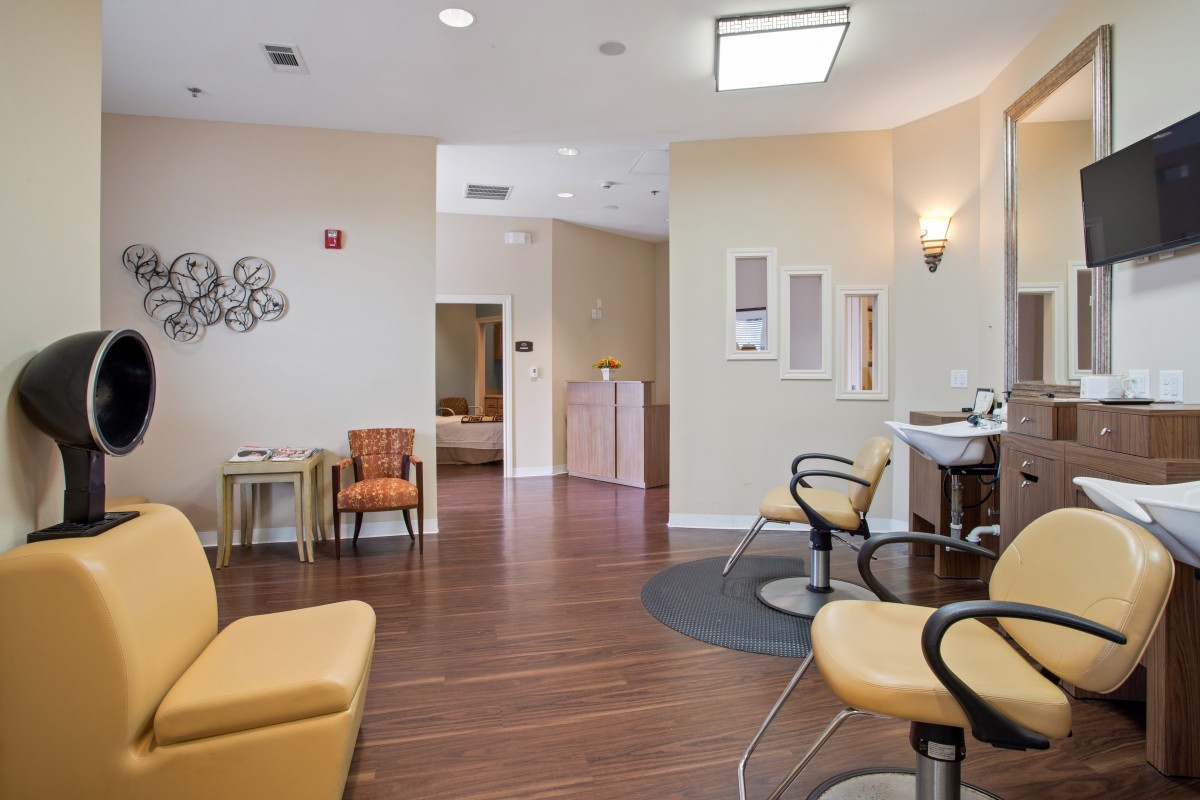 A modern salon interior with comfortable chairs and a waiting area.