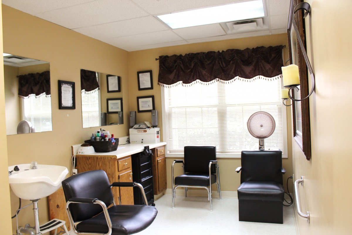 A cozy hair salon interior with styling chairs and mirrors.