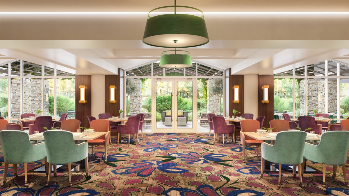 A modern dining area with colorful carpeting and stylish lighting.