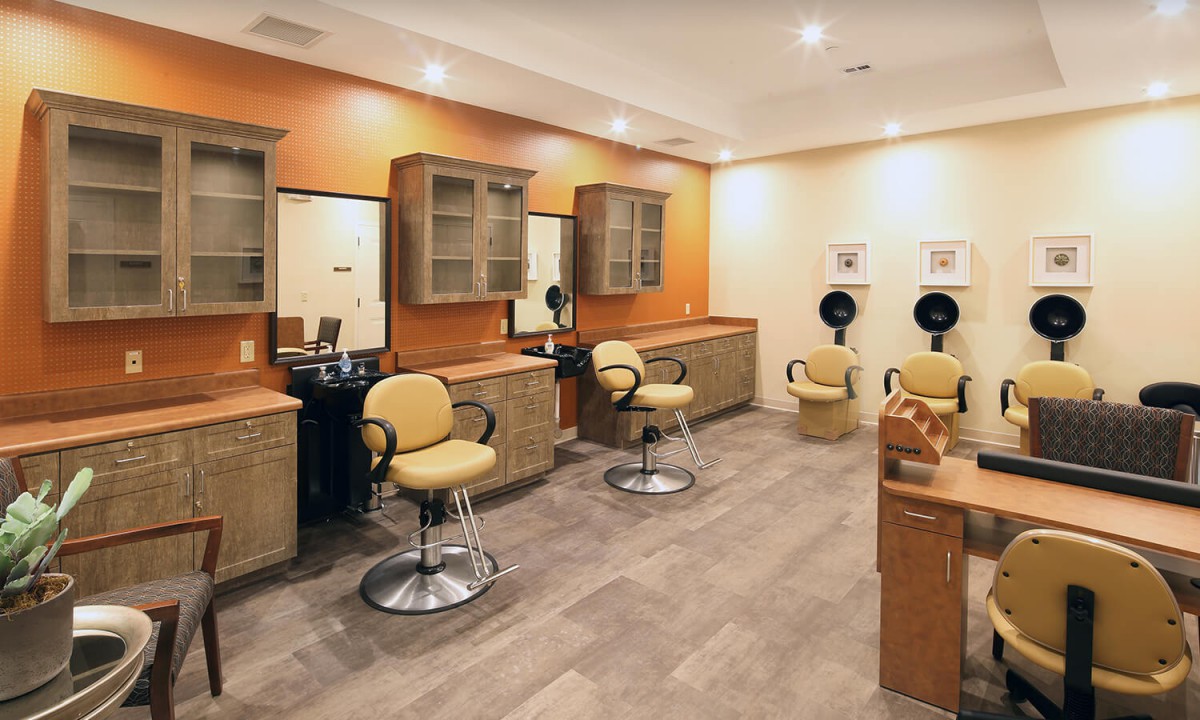 A modern salon interior with styling chairs and mirrors.