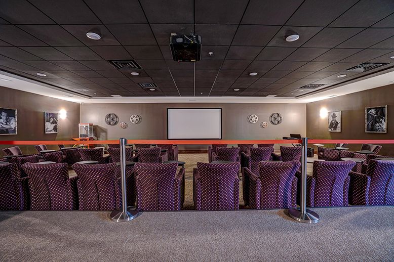 A home theater with comfortable seating and a large projector screen.