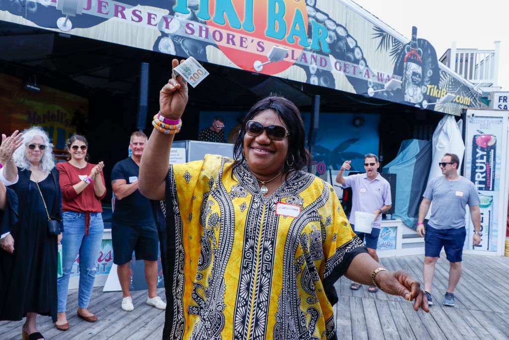 A joyous person celebrating outdoors at a lively event.