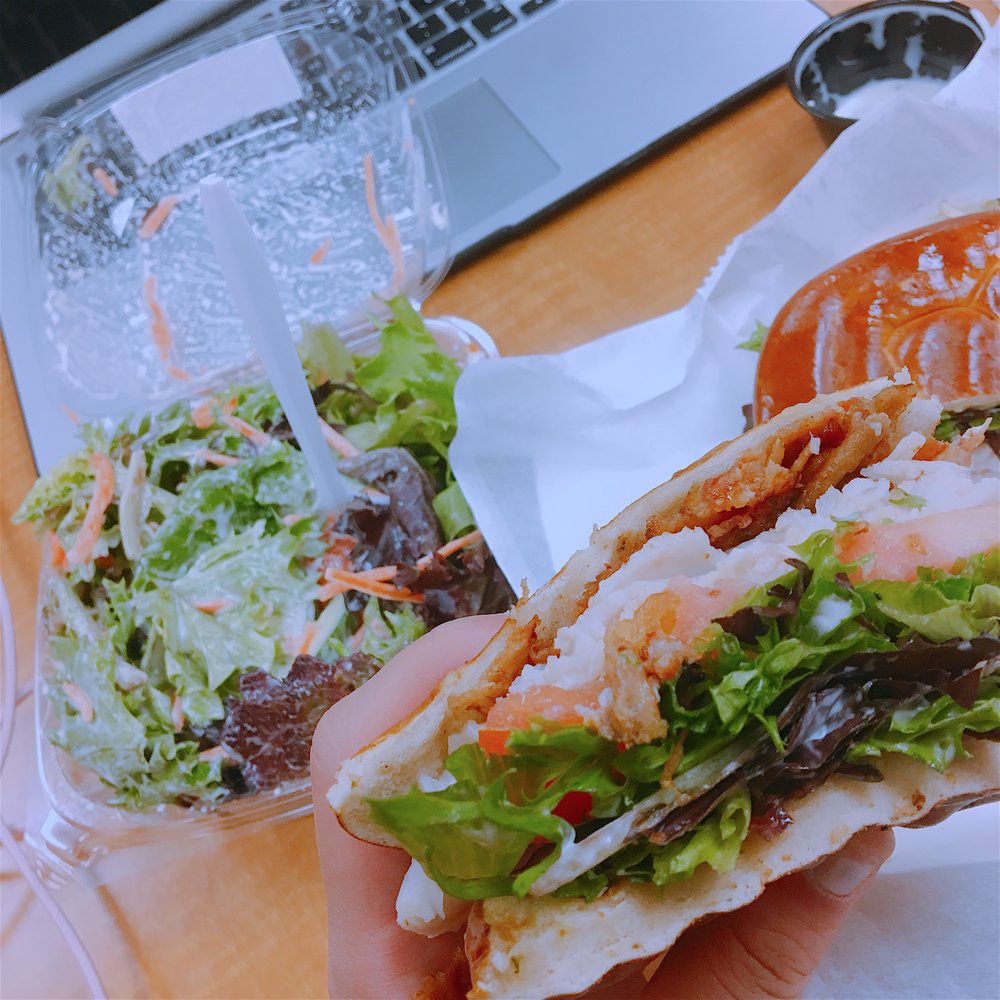 A fresh and healthy lunch featuring a sandwich and a salad.