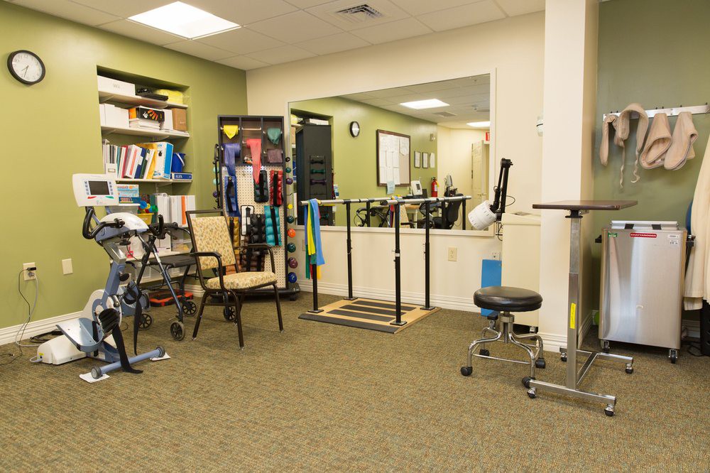 A physical therapy room equipped with various rehabilitation tools and exercise equipment.