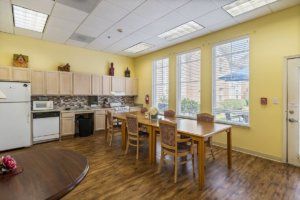 A bright kitchen and dining area with large windows, providing ample natural light.