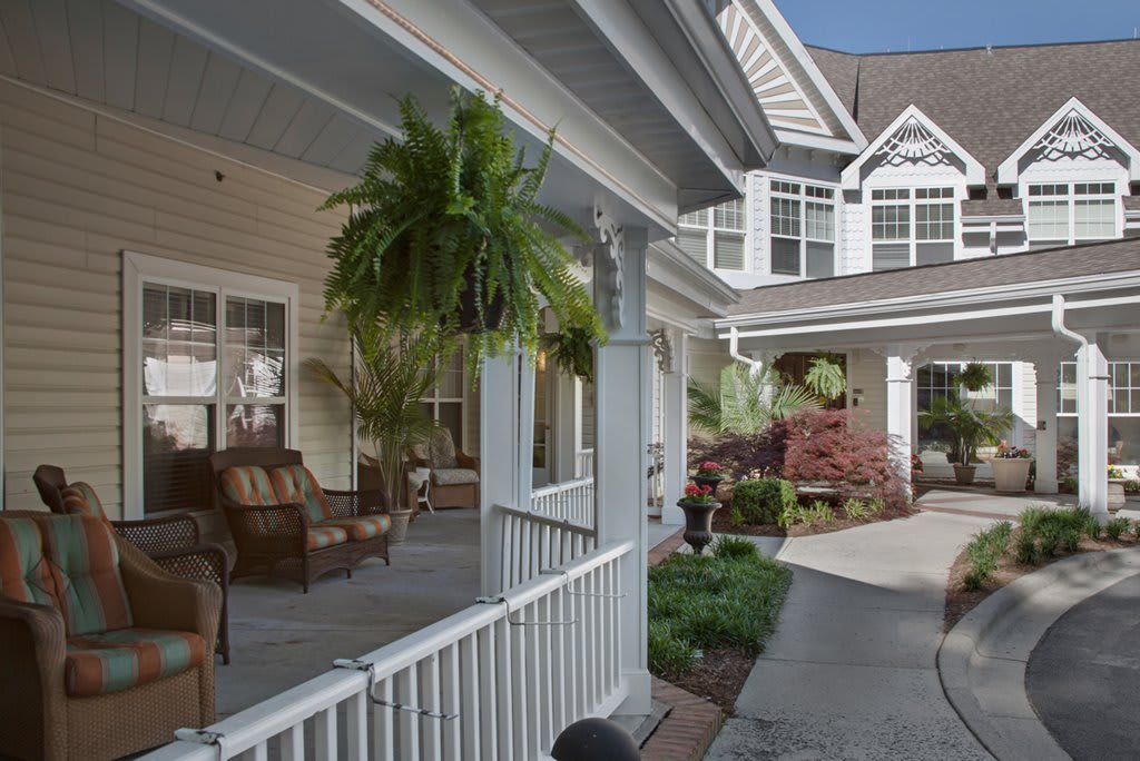 A charming house with a cozy porch and well-maintained garden.