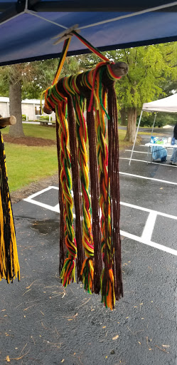 Colorful handmade textile decor showcasing vibrant patterns at an outdoor market.
