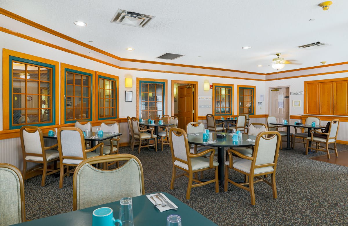 Empty restaurant dining area with neatly arranged tables and chairs.