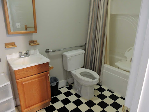 A compact bathroom featuring essential amenities including a toilet, sink, and shower.