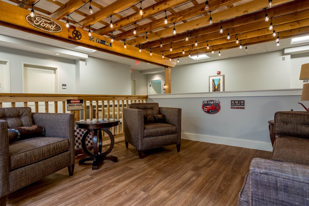 A cozy waiting area with comfortable chairs and decorative lighting.