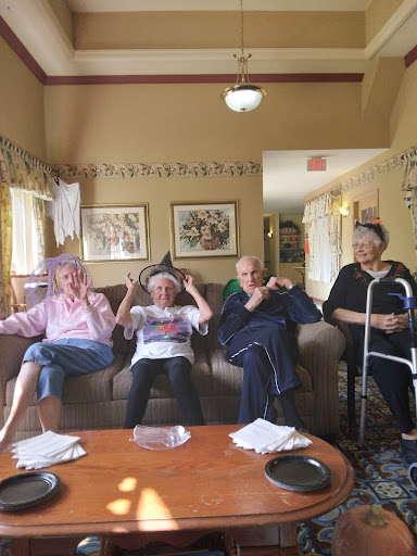 A joyful moment shared among friends at a care home, celebrating togetherness and laughter.