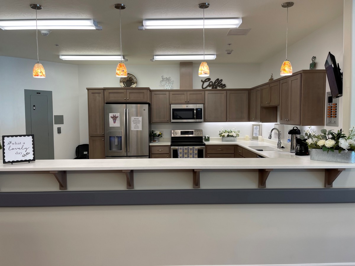 A modern kitchen with stainless steel appliances and wooden cabinets.