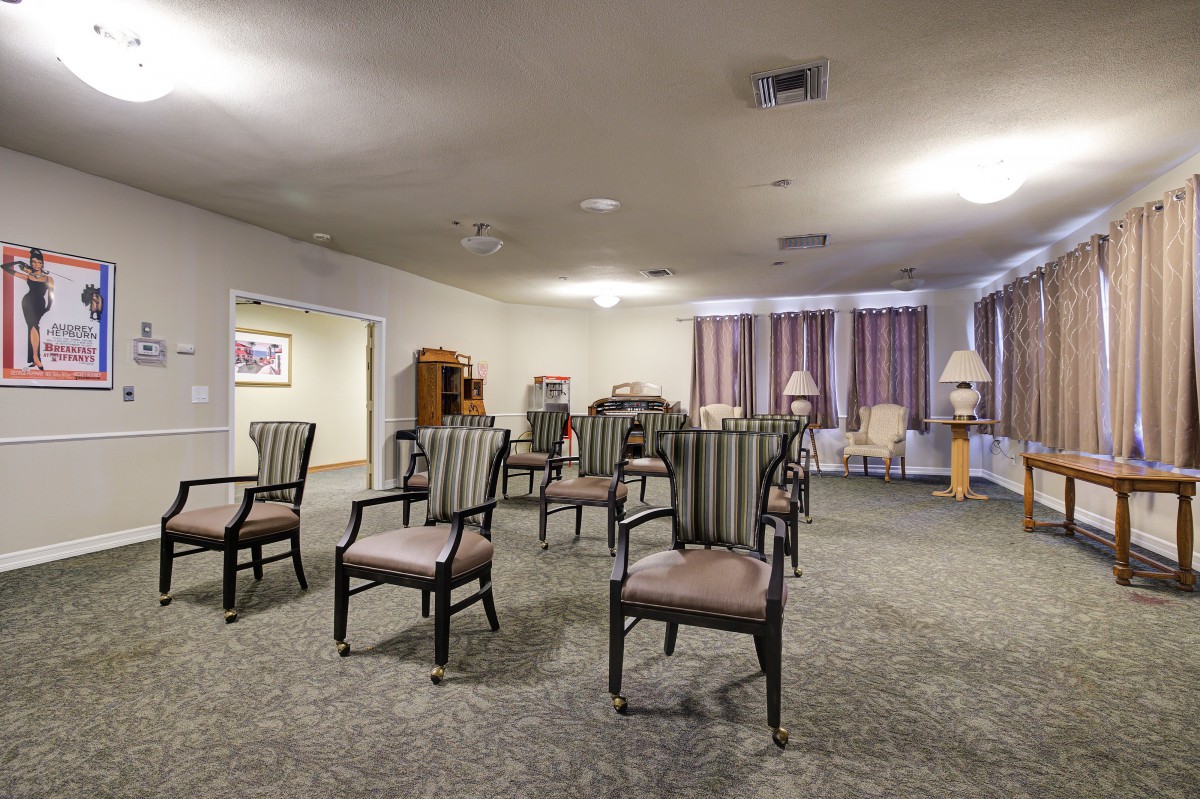 An empty room with arranged chairs, suggesting a meeting or event space.