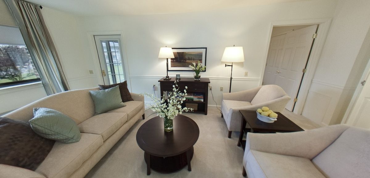 A cozy living room with comfortable seating and elegant decor.