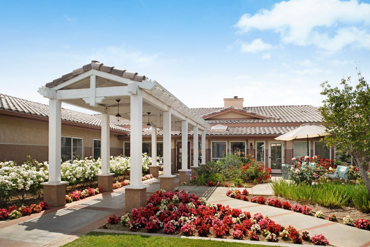 A well-maintained residential building with a beautifully landscaped garden and walkway.