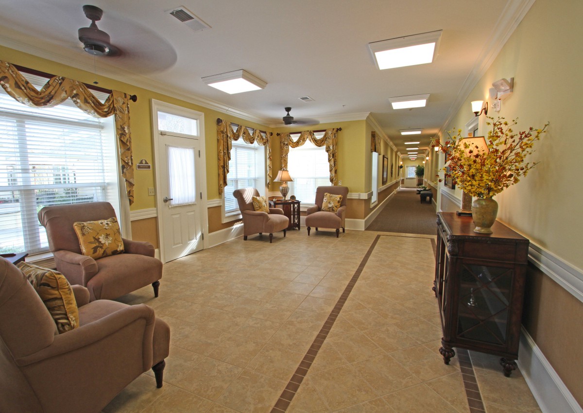 A luxurious hallway with elegant seating and ornate decor.