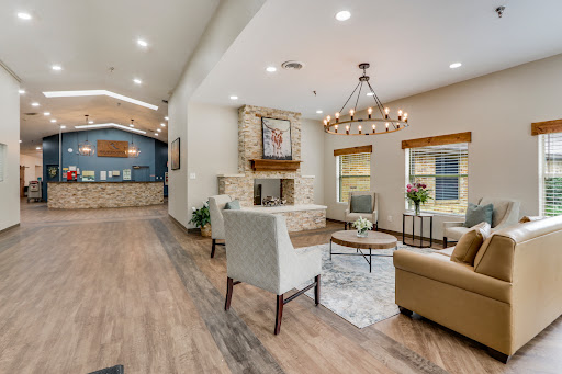 A beautifully designed modern living room featuring a cozy fireplace and elegant chandelier.