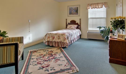 A cozy bedroom with a single bed and floral decor.