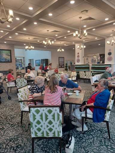 Seniors enjoying a meal and conversation in a cozy dining area.